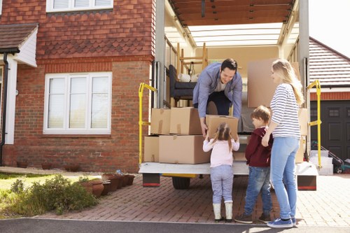 Removal team using safe lifting practices during a move