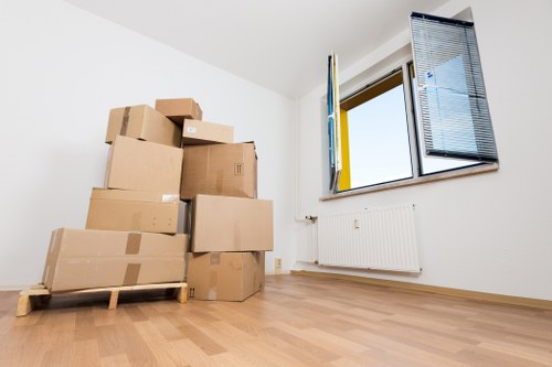 Mover carrying furniture with care during a house move
