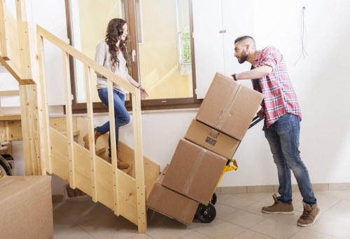 Professional movers preparing wrapped furniture for transport