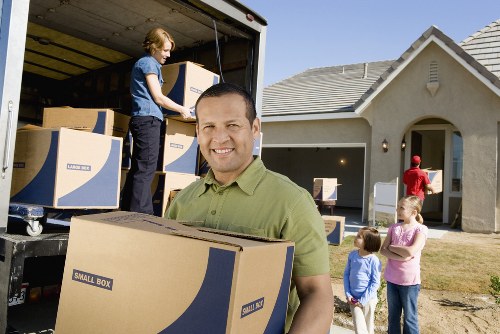 Packed moving boxes arranged safely in a property corridor